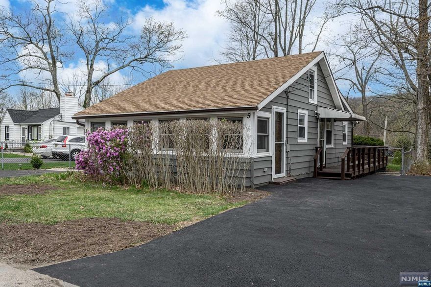 *Newly Remodeled* in 2024, this 2 Bed 1 Bath Ranch in Lake Hopatcong Gardens is more than meets the eye! EVERYTHING NEW, with easy lake access, & so much more!! This charming home features a light and bright open layout with brand new luxury flooring, recessed lighting, and a crisp neutral palette that is easy to customize. Beautiful, spacious Sunroom features a soaring vaulted ceiling and panoramic views, sure to impress! Sleek Eat-in-Kitchen offers SS Appliances, breakfast bar, gorgeous quartz counters, pantry storage, tiled backsplash and access to the rear deck for easy al fresco dining. Two generous Bedrooms have lighted ceiling fans for added comfort. Sizable Full Bath with ceramic tiling features a convenient in-unit laundry hookup. Charming fenced-in Backyard offers a wrap-around Deck with retractable Awning & storage shed. 2 Driveways is an added bonus, offering ample guest parking. Generac Generator & Newer HWH, too! Steps to the Lake, Hopatcong State Park, and more!