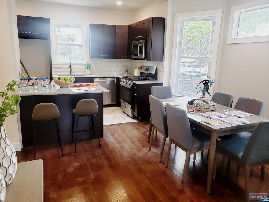 Welcome home!! Hardwood floors and tons of nature light throughout. A new modern kitchen, granite counter-tops, stainless steel appliances & a beautiful open concept . This property offers nothing but space..Great Living/Dinning room, followed by an gorgeous 1st floor bathroom. The 2nd floor continues to usher in natural light throughout, offering 3 bedrooms and a trendy hallway bathroom. It doesn't stop there, continue to the third floor, where you have two additional bonus large sit-down area follow by another bedroom! This house has it all, every inch of space has been maximized. The finished basement, offers a washer & dryer hook, an additional bonus room. With all this property has to offer plus a tax abatement for 5 yr on top yeah! low taxes, all that's left for you to do, is move in!!! This property is located near parks, public transportation & easy access to NYC & all highways. Get in just in time for fall & enjoy your spacious backyard & front porch.