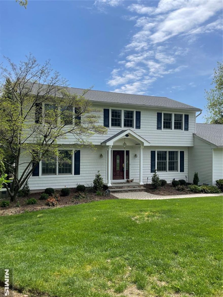 Beautiful and classic Ridgewood colonial located at the end of a cul de sac. Short distance to Orchard Elementary School and train to NYC. The entry foyer leads you to the formal living room, a formal dining room, and a family room with a wood burning fireplace. The main floor continues with a custom Ulrich kitchen with access to a Trex deck, powder room and laundry. Upstairs you'll find 4 bedrooms including the primary suite featuring a gorgeous updated bath with radiant heat and walk-in closet. An updated hall bath and plenty of closet space complete the second floor. The walkout basement is spacious with a rec room, home office, full bath and plenty of storage. Some features include Hardwood floors, 5 zone heat, whole house vacuum, solar system, whole house generator, Wolf and Sub-Zero Appliances, granite counter tops, breakfast bar, beverage refrigerator, induction cook top, convection oven and warming draws. This is a special home that has been loved and cared for by the owners for 28 years.