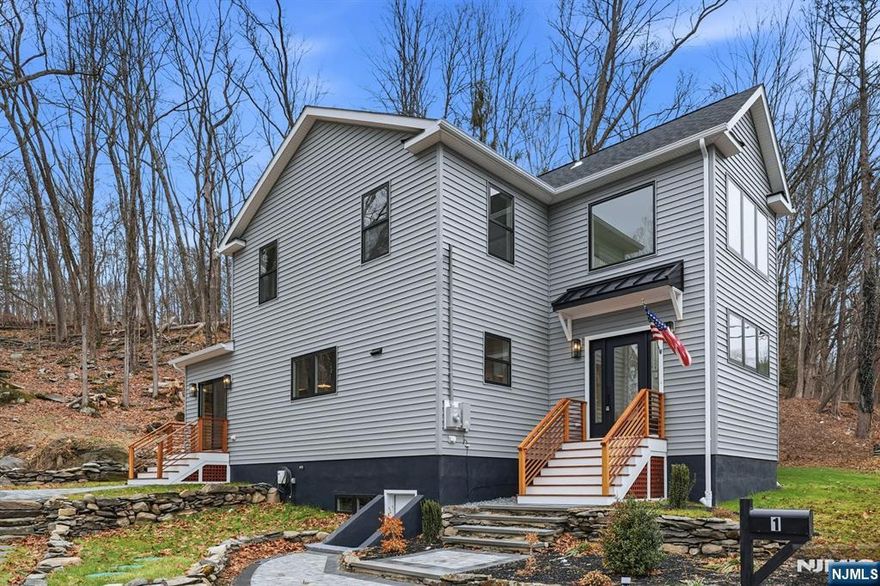 Welcome to this stunning, newly constructed single-family home in the heart of Blairstown. Thoughtfully built on an existing foundation, Step into a striking two-story entrance foyer featuring a quarter-turn staircase accented by a modern multi-light glass globe chandelier. The first floor boasts an expansive open concept with a formal living room featuring two skylights, a fireplace, and sliding glass doors that lead to the front patio. The dining area includes a custom bar nook with a sink and wine cooler, ideal for entertaining. The show-stopping chef's kitchen is equipped with a massive center island, brand-new stainless steel appliances, and a built-in microwave tucked neatly into the island for added convenience. Additional first-floor features include a private office space and a modern half bath. The 2nd floor offers four generously sized bedrooms. The primary suite is a true retreat, featuring top-tier walk-in closets and a luxurious full bathroom. Three additional bedrooms offer ample space and storage, complemented by a second full bathroom. A well-appointed laundry room with sink and cabinetry is conveniently located on the same level. An attic for extra storage space. Additional Features Include Large windows throughout for natural light, Dual-zone central heating and air conditioning, a Brand-new septic system, and private driveways. Located minutes from Blair Academy, local farms, shopping, dining, and major commuter routes. Don't miss out!