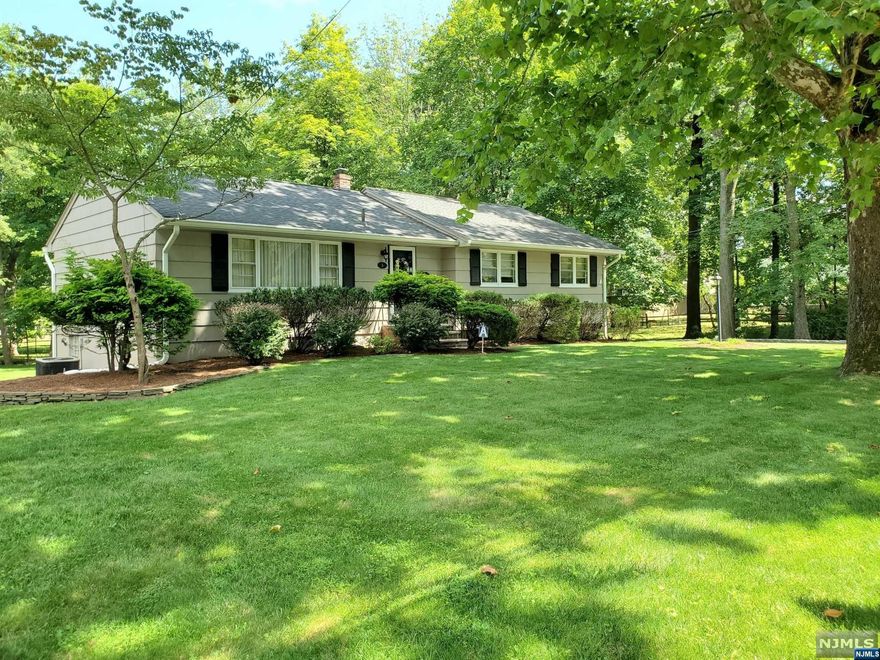 Updated & immaculately maintained Ranch home in Demarest, a charming Bergen County gem town. Rare opportunity to purchase a spacious move-in ready home on an expansive picturesque lot of almost 3/4 of an acre. Current owners treasured it for nearly half a century, now it can be your own pride & joy. Calling all artists who would love to paint their private quaint backyard brook, how about a little garden-bridge to complete the picture? Other features include: updated eat-in-kitchen w/gorgeous cherry cabinetry & access to high rear deck overlooking backyard, 2 updated bathrooms, spacious primary bedroom suite w/3 closets & private bathroom w/shower, hardwood-floors throughout including under bedroom carpets, central A/C, attached 2-car garage w/extra storage space & access to home, sliding lower-level doors to large stone patio. Crown moldings in large living room, dining room, kitchen & bedroom suite. Award-winning schools & walking distance to NYC bus at the beautiful duck pond.