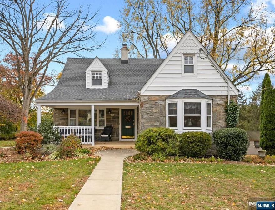 A beautifully maintained Cape Cod blending timeless craftsmanship with thoughtful updates. Step through the foyer into a warm living room anchored by a wood-burning fireplace, framed by built-in bookshelves and detailed crown molding. The formal dining room features a charming bay window and built-in china cabinets, creating an effortless flow for both everyday meals and entertaining. At the heart of the home, the kitchen offers granite countertops, a center island, stainless-steel appliances, and a convenient side-door entry. Down the hall are two spacious bedrooms, a full bath, and a built-in desk area designed to keep life organized. The primary bedroom extends to a bright three-season sun porchâ€”an ideal spot to start or end the day. Upstairs, two additional bedrooms offer generous storage, including a walk-in closet and access to a large attic room. The lower level feels like its own retreat, featuring a family room with a second fireplace, a bonus room, a wine tasting room, a full bath, and walk-out access to a covered patio and the two-car garage. Recent updates add comfort and peace of mind, including a new roof (2021) and two-zone central air (2024). Moments from downtown Midland Park, schools, parks, the library, and transit, this home delivers a perfect balance of charm, space, and convenienceâ€”your next chapter begins here.