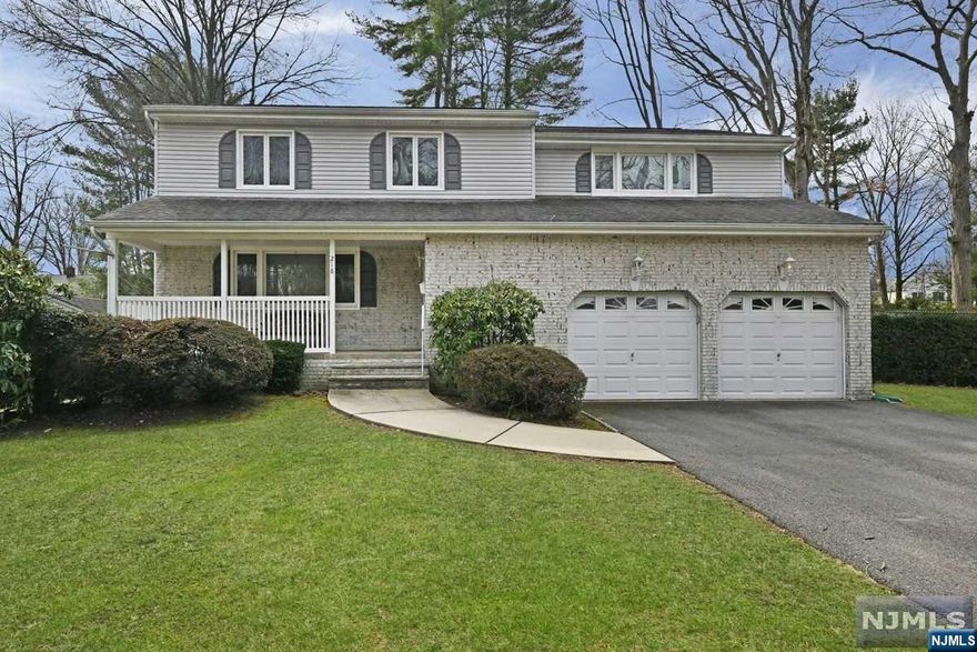 Imagine enjoying morning coffee & afternoon lemonade on your front open porch on a cul de sac? It's not often you can find this in Paramus, but you will here. Step inside to find an entry foyer w/dble coat closet, Formal LR & DR combo (was previously only a Formal LR, can be reverted back) & additional Dining rm. Beautiful, updated MEIK w/granite counters & breakfast bar, SS appliances, pull-out drawers, spice rack & lazy Susan. Next is the Powder rm/laundry rm combo. Step down to Family rm w/electric FPL(neg.) & sgd to patio. Interior access to 2 car att gar. 2nd fl: Hardwood floors under carpet. Extra large 23'9"x 20'4" MBR w/huge 9'5"x 9'5" walk-in closet. 3 more large bdrms. Updated hall bath w/double sink vanity. Finished bsmnt w/lots of storage & Family rm 23'6 x 23'3". 2 sump pumps, 1 w/battery backup, keep bsmnt waterproofed. C/A/C. Replacement windows. Newer gar & entry doors. Close to NYC bus, elementary school & parks. Within 1 mile to several houses of worship
