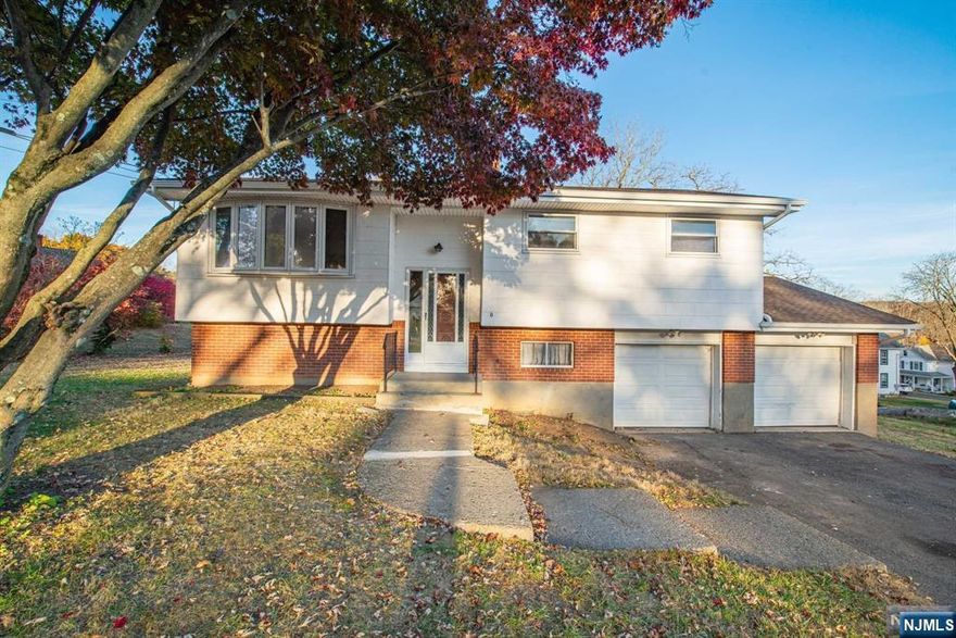 This house has a BRAND NEW ROOF, NEW GUTTERS, NEW BOILER, and the septic was fixed, as well as a new shower and floor in the downstairs bathroom. WELCOME to this beautiful bi-level! This property boasts an open living & dining room area on the top floor next to the fully equipped kitchen.Down the hall you will find closets for storage, the first full bath, and three bedrms. While most of the house is carpeted with hardwood floors underneath, the top floor bedrms have original hardwood floors. On the lower level, you will find a bonus room, as well as a living space that offers cabinetry & a sink perfect for both indoor/outdoor entertaining with a door that leads to a patio & into the spacious backyard. You will also find the second full bath with newly renovated shower & floors, laundry room,& space for storage. In addition, there is a 2 car attached garage with work bench as well as additional attic storage.