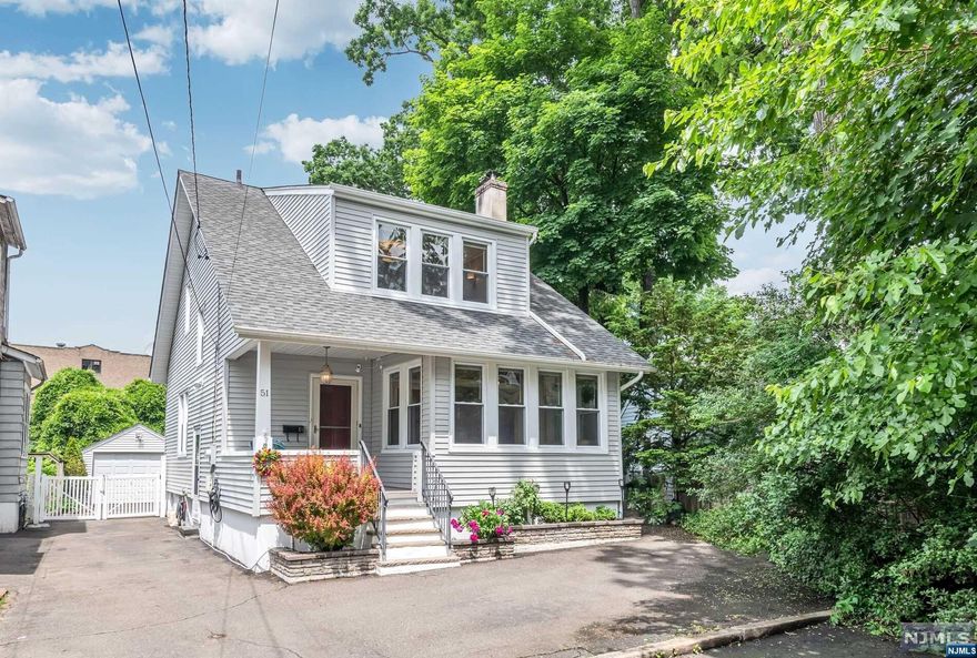 Welcome to this classic colonial on a cul-de-sac in the heart of Ridgewood, just blocks from downtown, NYC bus and train. Enter through the covered front porch into an open floorplan featuring a cheery sunroom, living room, and spacious dining room with coffered ceilings. The nearby kitchen, equipped with stainless steel appliances, leads to a deck perfect for entertaining. A convenient first-floor full bath completes this level. Upstairs, you'll find three large bedrooms with walk-in closets and a hall bath with a jetted tub and stall shower. The lower level offers great potential with high ceilings, storage, systems and laundry. Outside you will find a fully fenced yard and oversized garage. Beautiful hardwood floors, custom millwork, and original stained glass windows add character to this charming house you'll want to call home.
