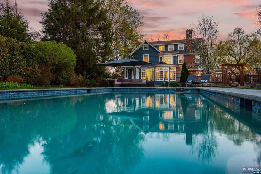 Situated in the curve of magical Sunset Park is this elegant center hall colonial; a perfect marriage of classic details and modern finishes. Fall in love from the moment you make your way up the bluestone walkway and enter the sunblasted foyer. To the left of the foyer is a large, stunning, living room with gorgeous wood burning fireplace. Just beyond, a knock-your-socks off home office with exposed brick and a view to the outdoors. To the right of the foyer is the dining room which easily accommodates a large dinner party. Just past the dining room, the recently renovated kitchen boasting sleek, modern cabinetry, double ovens, cooktop, center island and all the storage you need. Kitchen opens onto the spectacular family room with its wall of windows to the yard offering a perfect view of the heated pool, outdoor kitchen and brand new outdoor fireplace. Primary suite features fireplace, walk in closet and primary bath with soaking tub, shower, and double vanity. This is heaven!