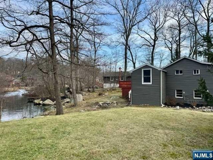 AFFORDABLE LAKEFRONT! 2 BR retreat located in charming Shady Lake community. Beautiful year-round lake views through the Living Room's entire wall of glass windows. Step outside to the huge deck or to the peaceful and private yard facing the water. Newer windows in the Living Room. Newer siding. Newer kitchen with brand new floor. Brand new electric fireplace stove. Home is freshly painted and move in ready. Lots of workspace off the garage. Home is being sold in AS-IS condition. Inspections for buyers own knowledge, seller will do NO REPAIRS. Close to routes 287 and 23 for major shopping. Located approximately 35 miles from the Lincoln Tunnel makes this adorable home a perfect getaway or short-term rental income. Enjoy fishing, boating, hiking and all the beauty of nature in this serene setting.