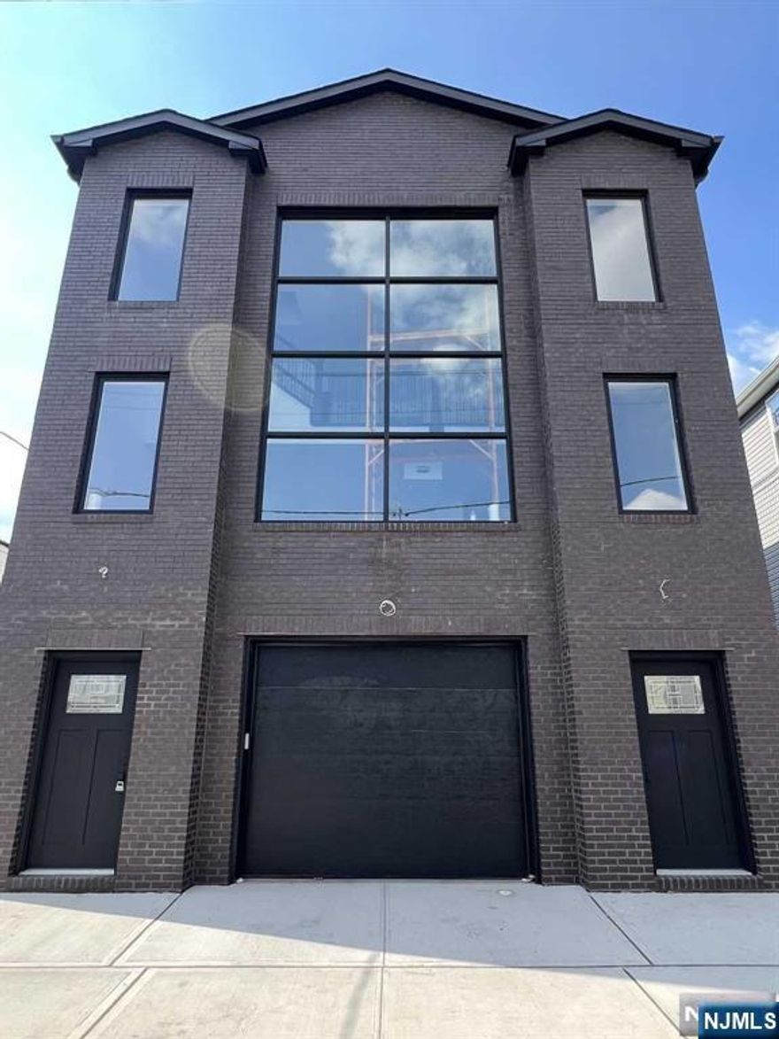 Luxe Listing Alert! Experience luxury like never before with this RARE new construction masterpiece in the heart of Newark, NJ! This isn't just a home; it's a statement. With two ultra-modern duplex units, this property is perfect for the savvy buyer looking for both style and substance. The top floor unit offers three large bedrooms, two bathrooms, a stunning rooftop deck with views of NJ, and a chic mezzanine area that adds a sophisticated touch to the already spacious layout. The bottom-floor unit also features three large bedrooms and exclusive access to a private backyard, your own retreat in the city. Every inch of both units has been designed with meticulous attention to detail, from the open-concept living spaces to the sleek kitchens. With nothing else like it in Newark, this property won't be available for long. Schedule a private showing today and experience this Luxe Listing yourself! 10 Year Builder's Warranty included. Property qualifies for 5 year tax abatement.