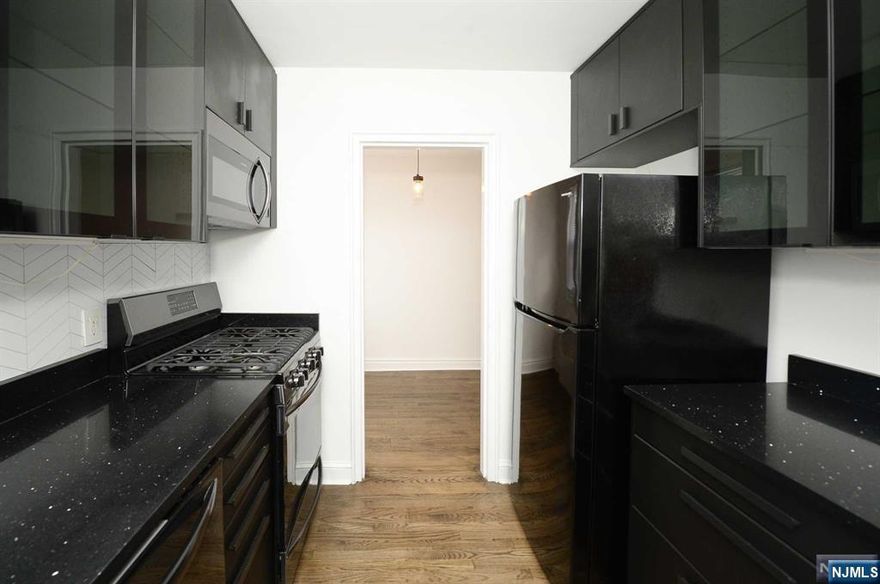 Step into this beautifully designed second-floor 1-bedroom apartment that exudes modern charm and sophistication. Featuring hardwood flooring throughout and flooded with natural sunlight, this unit creates a warm and inviting ambiance. The spacious layout includes a large living room seamlessly connected to a dining area, perfect for entertaining or relaxing. The modern kitchen stands out with sleek black cabinets, offering both style and functionality. A cozy bedroom provides a peaceful retreat, while the full bathroom completes this thoughtfully designed space. Located in the heart of bustling Englewood, this apartment provides unbeatable access to everything the neighborhood has to offer. Enjoy a dynamic lifestyle with renowned restaurants, boutique shopping, and trendy fitness studios just steps away. This is your chance to embrace the perfect blend of comfort, style, and convenience. Schedule your tour today and make this stunning apartment your new home!