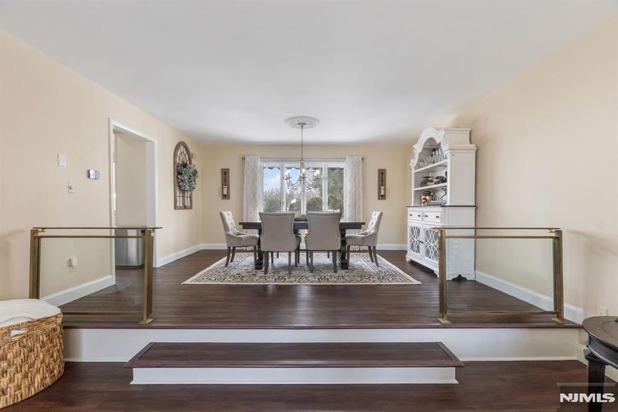 This lovely home has been meticulously updated for ultimate convenience. The main level has a an airiness with it's spacious living & dining rooms with rich hrdwd flrs into a beautiful EIK. Outfitted with quartz counters & stainless appliances, the kitchen flows into a cozy breakfast nook. The backyard is a private retreat for summer bbqs or quiet reflection after a long day. Upstairs, 4 nicely sized bedrooms supported by 2 full baths with sophisticated, modern fixtures. The ground level offers a quiet space for a home gym or media room. Living here means you are part of a neighborhood where weekend mornings are spent visiting local cafes or shopping on the Boulevard. The location is a dream being positioned minutes from the Teterboro & Wood-Ridge train stations, while the NJ Transit 163 bus takes you direct to Port Authority in 45 min. With immediate access to Route 17 and I-80, the home serves as a serene sanctuary that never feels isolated from the energy of the city.