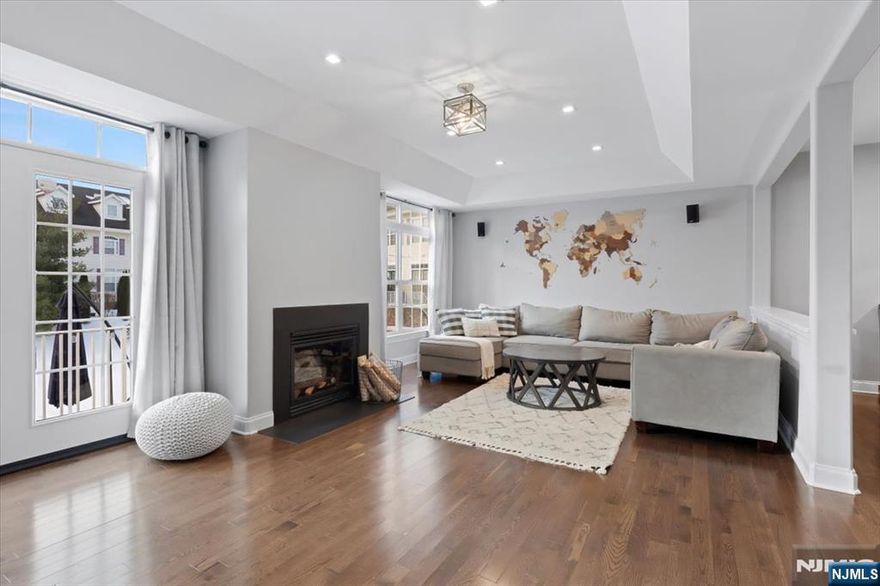 Welcome home to Barnhardt Lane in Rahway, where understated luxury and refined design come together in effortless harmony. A bright, dramatic entry foyer with soaring ceilings and rich new hardwood floors creates an immediate sense of openness and warmth, setting a sophisticated tone throughout. The space unfolds seamlessly into a sleek modern eat-in kitchen featuring a tasteful backsplash and space for a cozy breakfast nook. Just beyond, an elegant formal dining room and an inviting living room with a gas fireplace and patio access create the perfect backdrop. A beautifully updated powder room, renovated in 2019, completes the first level. Upstairs, a striking staircase enhanced by a designer accent wall and soft baseboard lighting leads to the private quarters. The sun-drenched primary suite serves as a tranquil retreat, showcasing expansive windows, a spacious walk-in closet, and a spa-inspired en-suite bath thoughtfully remodeled in 2024. This level also features a conveniently located laundry area, an additional generously sized bedroom, a beautifully updated full guest bath with radiant heated floors completed in 2022, and a versatile den. A private third-floor level offers exceptional flexibility, currently designed as a home gym, along with abundant storage and convenient attic access. Ideally positioned just eight minutes from Rahwayâ€™s vibrant downtown and train station, the home offers a seamless commuting.