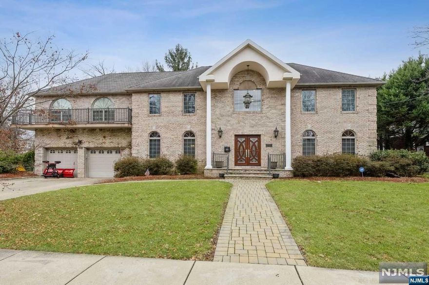 Beautiful brick corner colonial in one of the most desirable areas of Nutley. Bright, high ceilings featuring an open foyer, stunning chandelier, airy floorplan, huge primary suite, two gas fireplaces, theater room, home gym space and open kitchen fit for a Chef featuring two ovens and a breakfast bar. Formal dining room and living room connect off the kitchen which leads to an everyday dining area that flows into the family room with a gas fireplace. The flowing first floor leads out to a two-level paver patio perfect for entertaining and relaxing with a custom built firepit. Back in the center hall, a gorgeous iron staircase leads to the second floor featuring three large bedrooms, a stunning primary suite with two walk-in closets, a separate seating area, gas fireplace, full bath with a Jacuzzi tub, custom stall shower and an additional half bath. Primary suite is surrounded by walkout balconies overlooking the serene backyard and view of the NYC skyline.