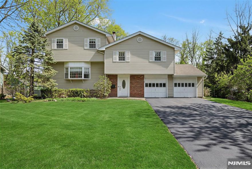 Nestled on a quiet cul-de-sac in Ridgewoodâ€™s premier Somerville district, this expanded and immaculately maintained multi-level home is truly turn-key. An inviting entry foyer leads up to a light-filled, open-concept first level where the living room, dining area, and modern kitchen flow seamlessly together. Just off the kitchen, the spacious family/rec room transitions perfectly to a powder room and the outdoors through sliding doors to a large, fenced backyard, complemented by a convenient powder room and laundry. The second level features three bedrooms, including a private ensuite, as well as a shared hallway bath. The true showpiece is the secluded top-level primary retreat - a thoughtful early-2000s expansion - boasting soaring vaulted ceilings, a generous walk-in closet, and a spa-like ensuite bathroom. Just off the kitchen, the spacious family/rec room transitions perfectly to the outdoors through sliding doors to a large, fenced backyard, complemented by a convenient powder room and laundry. With an unfinished basement offering endless potential (and the peace of mind of a 20-year no water/completely dry history) and a location just steps from Somerville Elementary, BFMS, and RHS, this is a rare opportunity in a prime location.