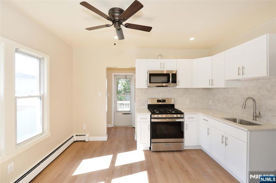 Spacious first-floor apartment in a newly renovated two-family home, ideally located just steps from NJ Transit and NYC transportation. The main level offers a comfortable living room, eat-in kitchen, bedroom with attached bonus room/office, and full bath. The ground floor adds additional living space, a bedroom, and laundry room access. Convenient location with great space inside and out!