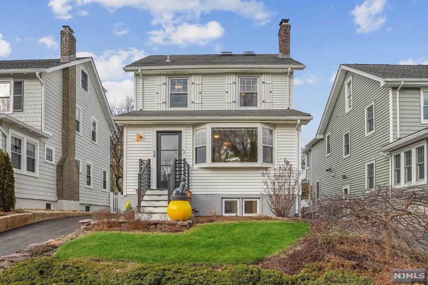 Welcome to this updated, chic, and light-filled farmhouse Colonial! So much to love about 34 Dodd St including the new exterior siding, doors, front steps, and back deck. The first floor includes sunroom open to Living Room with wood burning fireplace, updated kitchen with stainless steel appliances, powder room, and formal dining room opening to new spacious deck and slate patio. Upstairs offers three sun-filled bedrooms and renovated bath on the second floor and a skylit forth bedroom on the third floor. Finished lower level with family room, two home offices, and full bath. Deep backyard with two car detached garage with 240 volt outlet for electric car charging. Quiet street less than a mile to both the Walnut St and Watchung Plaza New York City train stations and villages. New York City bus on corner and entrance to 121-acre Brookdale Park just up Ridgewood Ave.
