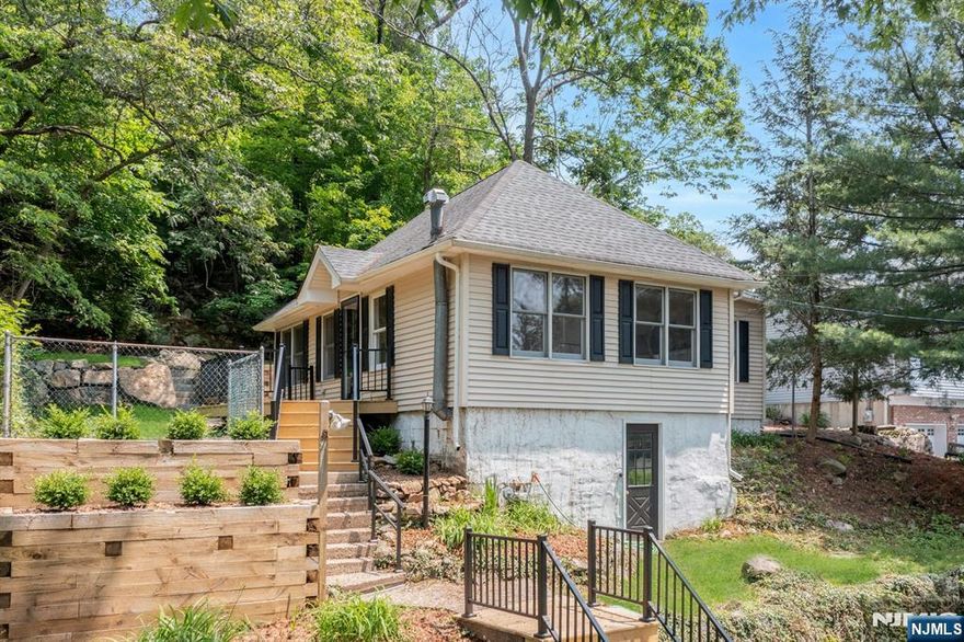 surrounded by natural beauty. Hardwood floors lead to a spacious living room with vaulted ceilings and a wood-burning fireplaceâ€”ideal for relaxing or entertaining. The renovated kitchen features classic white subway tile and new appliances including refrigerator, stove, microwave and dishwasher. The updated bathroom includes subway tile and fresh fixtures for a clean look.A laundry area offers convenience with washer and dryer included. Enjoy lake views from the private deck and patio. The large backyard provides space for outdoor living, and the oversized driveway allows off-street parking for six vehicles. Located in the scenic Highlands region, Ringwood offers preserved woodlands, trails, lakes, and landmarks like Ringwood Manor and the NJ Botanical Garden. Available nowâ€”schedule your tour today!