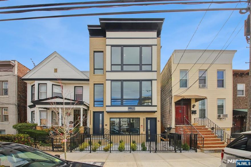 Welcome to the East Side of Jersey City Heights. Experience modern luxury living in this newly constructed condominium, crafted with exceptional attention to detail and high-end finishes throughout. Perfectly situated in one of the most desirable pockets of The Heights, this home combines style, comfort, and convenience. Step inside to a spacious open floor plan, highlighted by a stunning custom kitchen featuring sleek cabinetry, quartz waterfall island and countertops, and premium stainless-steel Thermador appliances. The dining and living areas flow seamlessly, complete with a built-in electric fireplace that adds warmth and ambiance. This home offers three bedrooms and two full bathrooms, including a beautifully appointed primary suite. Gorgeous 100% white oak flooring runs throughout, creating a clean, modern aesthetic. Custom closets, central air/heat and a dedicated washer/dryer room add to the homeâ€™s thoughtful design and functionality. One of the standout features is the extraordinary 1,060 sq. ft. private roof deck, showcasing spectacular New York City views and outfitted with 24â€ x 24â€ porcelain pavers and a built-in outdoor kitchen, itâ€™s the ideal setting for relaxation and entertaining. Located within walking distance to NYC transportation (bus and rail), top-rated restaurants, shopping, Washington and Riverview Parks, and exceptional schoolsâ€”PS 28 Christa McAuliffe (Pre-K3 through 8th grade)â€”this home offers unmatched convenience. 10-year builderâ€™s