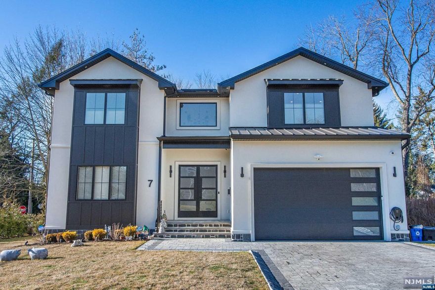 Welcome to your dream home! This luxurious, young home in Cresskill has 4 spacious bedrooms and 4.5 modern bathrooms, providing ample space for comfortable living and entertaining. Step inside and be greeted by an impressive 2-story foyer, which leads to an open floor plan, perfect for gatherings offering the flexibility and convenience you need. Filled with modern touches: 10' ceilings on 1st Fl, (9'ft on 2nd), Linear Gas Fireplace & Smart Lighting. The gourmet kitchen is a chef's paradise, that toggles between the dinning room, living room or family room and features an 8' Quartz Island. Looking for entertainment options? This home features an at-home media room, wine room, and wet bar- all designed to provide you with the ultimate in luxury and comfort. Additional features include lower level office(s) and solar panels for your electric vehicles. There are so many more features provided upon request! See Video Tour