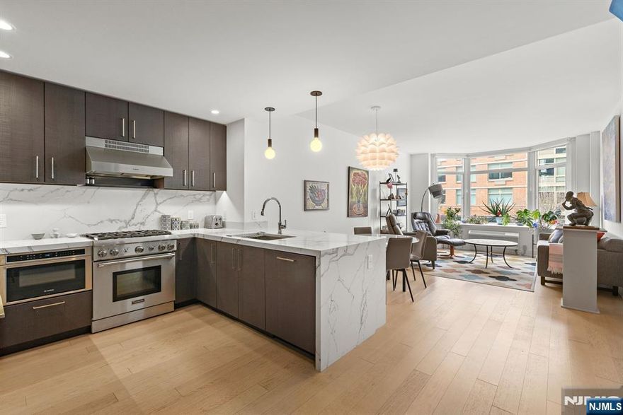 **OH - Sat (3/7) and Sun (3/8) 1PM - 3PM** Incredible 1150sqft 1 bed + den with parking in the luxury community of 1400 Hudson! Modern chefâ€™s kitchen includes quartz countertops, stainless-steel appliances, and breakfast bar. Spacious living area includes west-facing bay windows and extra-high ceilings. Primary bedroom has a walk-in closet and ensuite bathroom. Oversized den is perfect as an additional bedroom or office space. The home also features an additional half bath, hardwood floors, in-unit washer/dryer and 1 parking spot #25 conveniently on the same floor. Building amenities include 24/7 concierge, yoga room, cardio gym, weight room, rooftop pool, residentâ€™s lounge, billiards lounge, courtyard, several rooftops with firepits & BBQ grills, playroom, and shuttle to and from the Path train. Located near the ferry, bus to NYC, shops, restaurants, and everything uptown Hoboken has to offer.