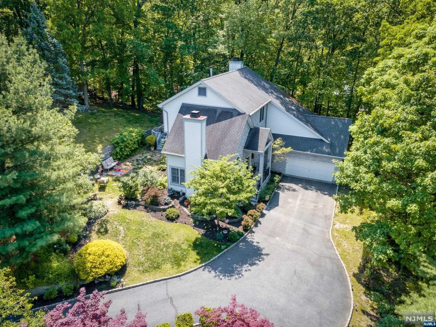 Beautiful Colonial in Prestigious Ramapo Mountain Estates! Amazing floor plan boasting over 2700 sq ft! You are welcomed into a Greatroom w/ cathedral ceiling, wood floors, custom windows, plantation shutters & gas Fieldstone fireplace! Open, airy floor plan features high ceilings, wood floors, crown molding, flooding with natural light! Open concept kitchen, dining area & Family Room w/another gas fireplace & walkout to deck. MBR suite is like a retreat! Cathedral ceilings, walk-in closets, luxurious private bath! 4 More large Bedrooms, 1 is located on 2nd level, perfect as guest room or office to work remotely. Wood floors throughout! Surrounded by beautiful mountain views! Large basement waiting to be finished! 1st floor Laundry! Relax & enjoy all the sounds of nature outside on the deck & yard! Close to NYC Express bus! Close to state parks, hiking & more! Pictures from previous listing. House is sold "As is" condition. Needs some TLC. 2 New HVAC units.