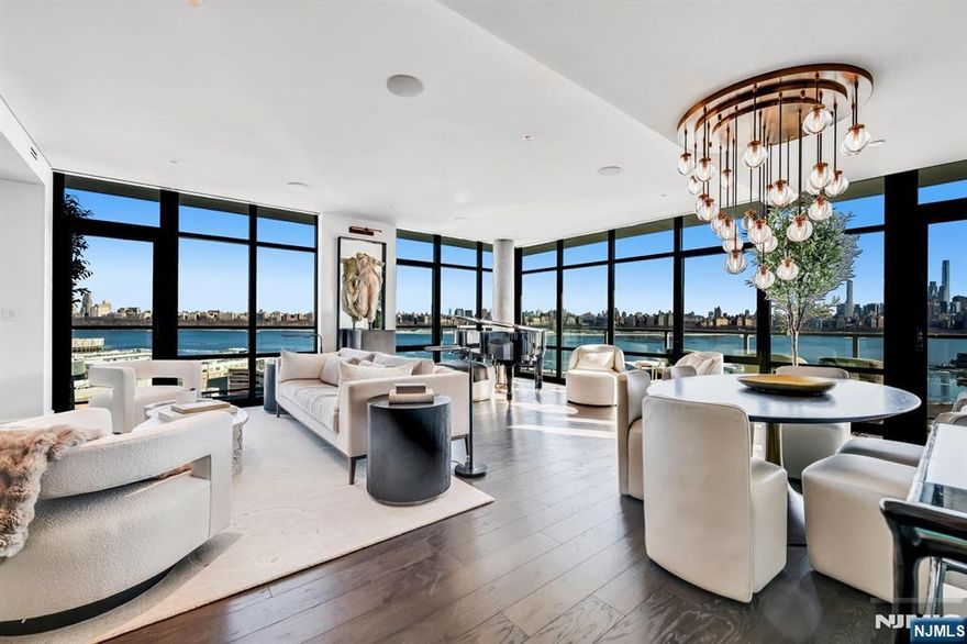 Introducing the pinnacle of luxury living, a breathtaking southeast corner penthouse atop one of the Gold Coastâ€™s newest waterfront developments. This 3 bedroom, 3 bathroom residence showcases exceptional design with natural stone, custom millwork, and refined finishes throughout. A stunning Orion Slim fireplace set in Zahara St. Laurent marble anchors the living space, complemented by dim-to-warm TechLighting controlled by Lutron. The chefâ€™s kitchen features Taj Mahal quartzite and premium Miele appliances, flowing seamlessly into expansive living and dining areas and a wraparound balcony with sweeping Hudson River and NYC skyline views. The primary suite offers a spa-like retreat with Calacatta Cremo marble, soaking tub, and Fantini fixtures. Secondary bedrooms each feature en-suite baths with custom walnut vanities and high-end stone finishes, while the third bedroom doubles as an ideal office. Additional highlights include a designer powder room with heated floors, custom laundry room, water filtration system, Sonos sound, electric shades, and integrated lighting. Residents enjoy a full-service lifestyle with resort-style amenities including outdoor fire pits, BBQ areas, a state-of-the-art fitness center, and The Sanctuary spa with sauna, steam, salt room, and more, plus resident lounge, co-working space, and rooftop lounge.
