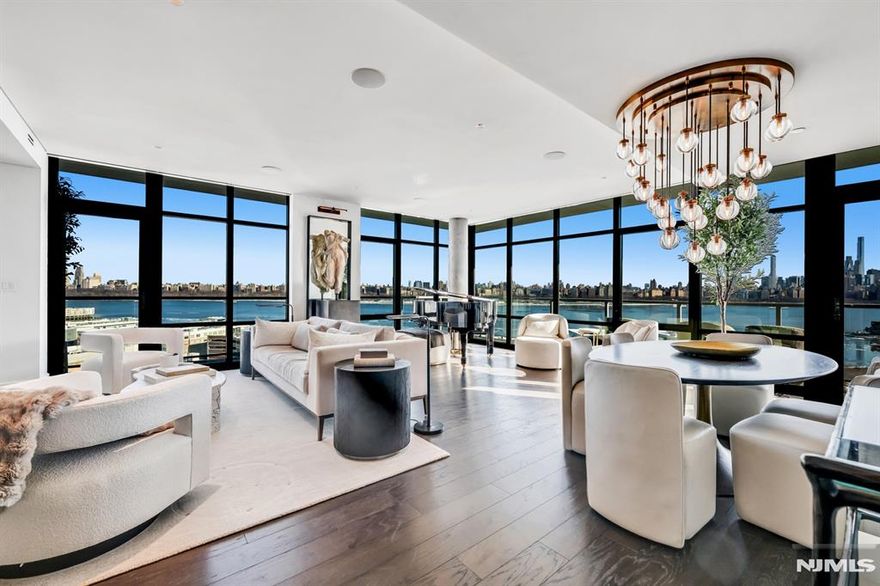 Introducing the pinnacle of luxury living: a breathtaking penthouse atop the South East Corner of one of Gold Coastâ€™s newest waterfront developments. This exquisite three-bedroom, three-bathroom residence is a masterpiece of design, blending natural stone, intricate millwork, and unparalleled craftsmanship to create an atmosphere of refined tranquility. Every detail has been meticulously curated, from the Orion Slim fireplace framed in Zahara St. Laurent marble to the dim-to-warm Essence lighting by TechLighting controlled via Lutron for an unparalleled ambiance. The wraparound balcony offers mesmerizing southeast views of the Hudson River and NYC skyline, seamlessly extending the grand living and dining spaces adorned with Taj Mahal quartzite surfaces and Miele appliances in the chefâ€™s dream kitchen. The primary suite is a sanctuary, with Calacatta Cremo marble, a jacuzzi tub, and Fantini Icona Deco fixtures, exuding opulence and comfort. Secondary bedrooms feature private bathrooms with custom walnut vanities, Naica quartzite, and luxurious finishes, while a versatile third bedroom doubles as an executive office. Additional highlights include a Naica quartzite-clad powder room with heated herringbone floors, a custom laundry room, a Springwell water filtration system, and a state-of-the-art Sonos sound system. With electric shades, integrated lighting, and shadow moldings casting depth, this penthouse offers an unparalleled blend of sophistication and modern living.