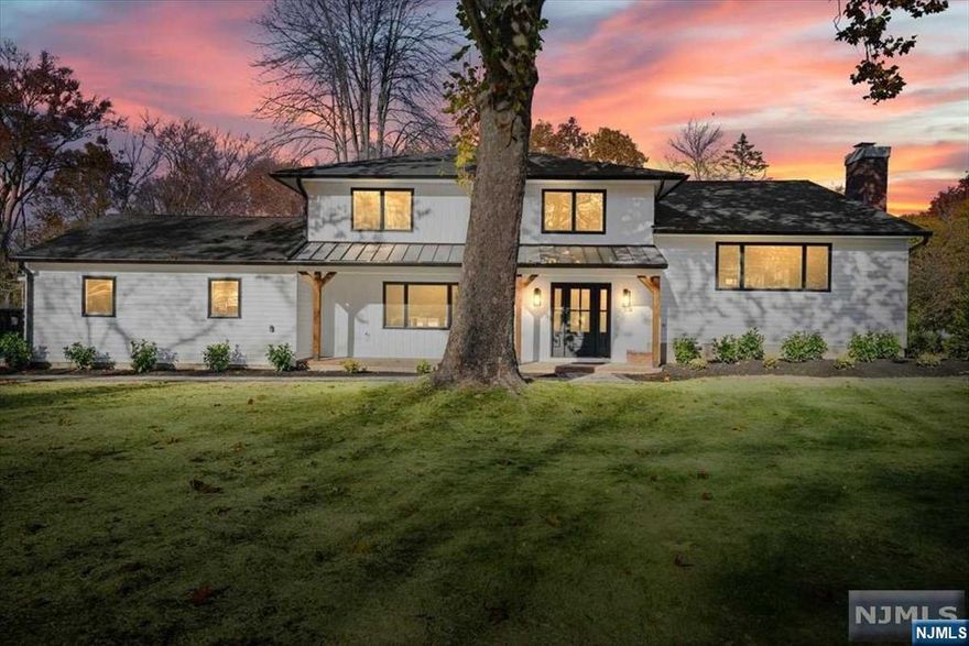 Set on 1.27 acres overlooking a serene pond, discover this completely remodeled home. With a clean, white exterior, accented with black-trimmed windows and rustic wood columns, this home exudes modern farmhouse elegance. The new paver walkway and patio will invite you to unwind outdoors, and inside, a herringbone tile leads to freshly painted, neutral-toned rooms with gleaming hardwood floors throughout the 1st and 2nd floors. The massive living room features a wood-burning fireplace and large picture window, while the chef's kitchen impresses w/ white shaker cabinets, an 8-foot island, quartz counters, and stainless steel appliances. Open to the dining room, the space is perfect for large parties or casual entertaining. Upstairs, the primary bedroom offers a wall of closets and a spa-like ensuite. Two additional bedrooms, full bath and a surprise walk-up attic complete the floor. The ground floor offers a family room, fourth bedroom/office, new full bath, and laundry.