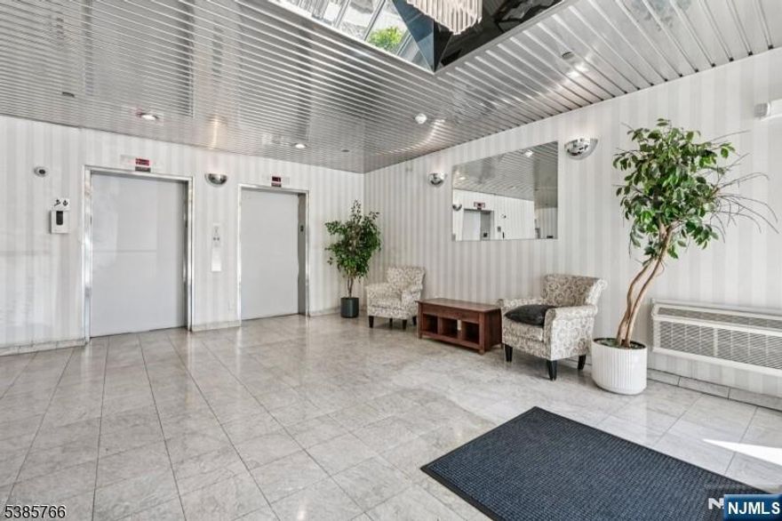 This charming and sun-filled 2-bedroom, 2-bathroom apartment offers the perfect blend of comfort, convenience and style. The primary suite features a private full bathroom and double closets. Sliding glass doors opens directly onto your own balcony from both living room and master bedroom perfect for morning coffee or evening unwinding. The second bedroom is generously sized, ideal for guests, a home office or additional family members. Enjoy central air conditioning throughout, in-unit laundry, and the added bonus of indoor garage parking. Steps from the NYC bus stop, commuting to the city is a breeze while you enjoy the quiet comfort of home. Please text 201-788-8138 for showings.