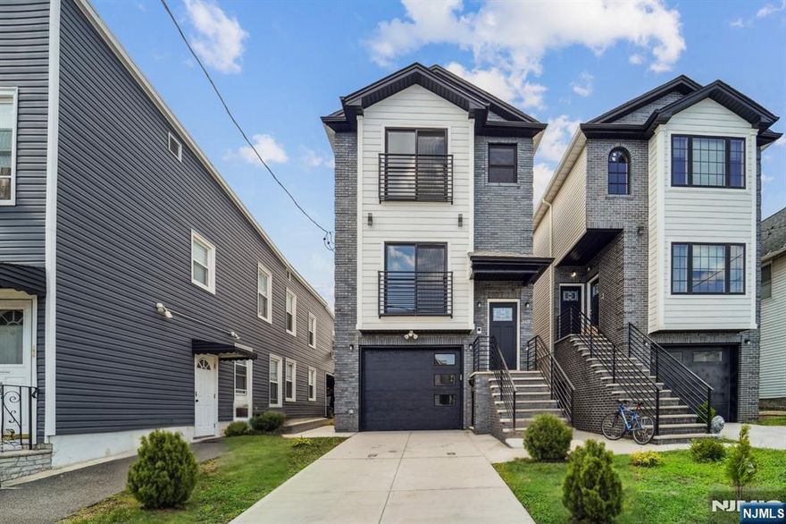 Welcome to your NEW Luxury Living! This beautiful 3000+ sq. ft home with 4 Bedrooms and 4 Bath custom property. Replete with expansive finishes and balconies. Step into this open style home boasting; 9ft ceilings, Anderson windows, Quartz countertops, custom, lavish oak flooring that one can't help but notice the sun filled rooms and flowing energy throughout. This home embraces the way we want to live. Equipped w/ home efficiency, recessed lighting, contemporary custom cabinetry. large modern kitchen with all stainless steel appliances. Perfect for dining in, cooking in & gatherings. Seamless access to the deck. Travel upstairs to 3 large bedrooms and 2 bathrooms. The Primary Bedroom features an ensuite luxury bathroom, and two walk-in closets. Level 1 find 1 Bedroom, bath, laundry area and a large family room with access to garage. Location surrounded by conveniences. Hassle free commuter options to NYC are steps away to Public transportation and Harrison Path Station min. to NYC.