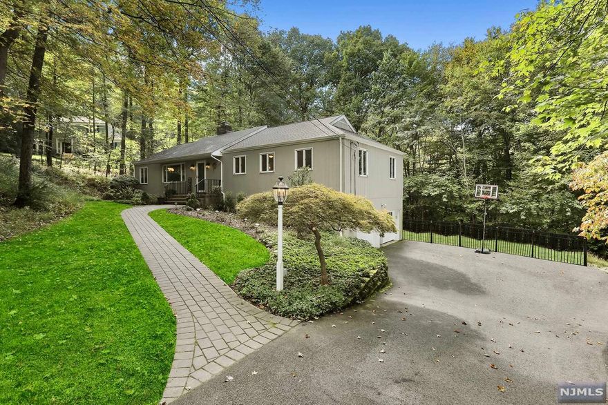 Beautiful expanded ranch in the Burnham Park neighborhood! Located on a cul de sac and backing up to county park lands, this delightful home is move-in ready. Easy entertaining in the sun-filled kitchen and family room with easy access to the deck. The ground floor office offers a separate entrance along with a full bath. The rec room is the perfect place for your personal gym or movie theater. Master bedroom with ensuite, new hardwood floors throughout the first floor, new appliances and garage doors. Excellent location less than 2 miles from downtown Morristown shops and restaurants!