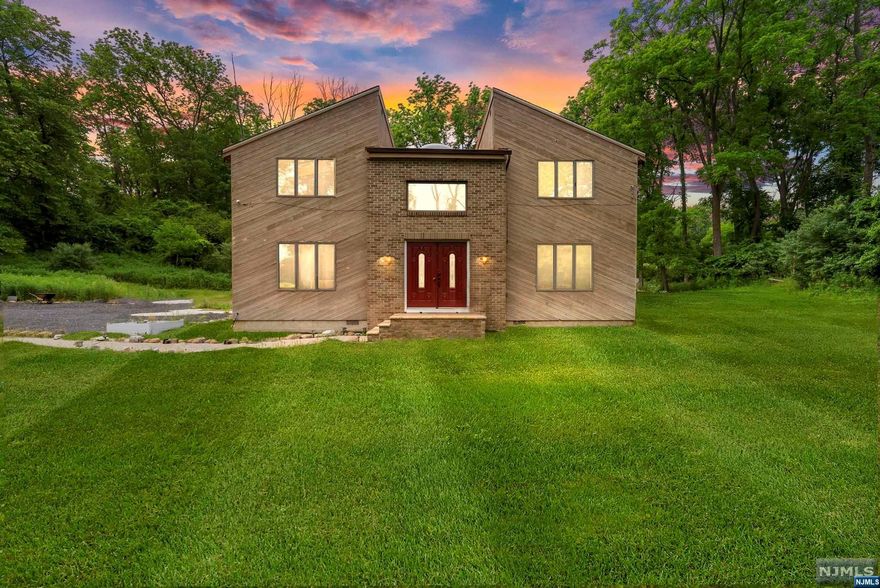 open and unique contemporary home in scenic Hope Township. Large family room is the center of the house and is open to the kitchen, living and dining room. Large windows and skylights throughout. The kitchen and family rooms have sliders to the large rear deck overlooking the level backyard. The property also boasts a large outbuilding and storage shed. Plenty of parking for extra vehicles as well. Upstairs are three sizable bedrooms and a full bathroom. The master bedroom has a skylight and a walk-in closet. The family room also features a wood burning fireplace. Easy commute on Route 80 and directly across the street from a farm with loads of open space. Take a look today!!