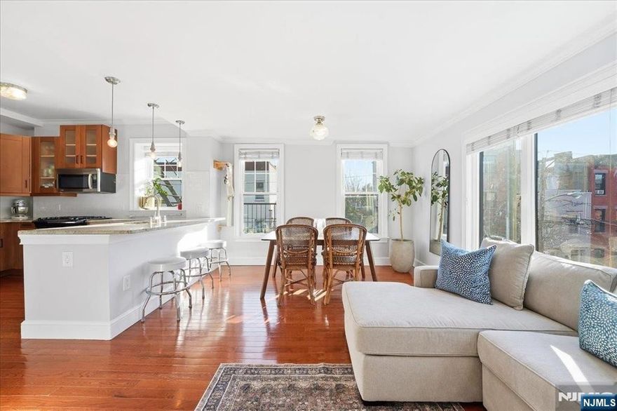 Welcome home to this bright, renovated corner 2-bedroom, 1-bath residence, filled with natural light and designed for everyday living. A wall of windows defines the open living and dining area, creating a sun-drenched space that feels both airy and inviting, ideal for entertaining or unwinding at home. The kitchen is thoughtfully laid out with abundant granite countertops, stainless steel appliances, a window for added light, and a breakfast bar with pendant lighting. The spacious primary bedroom features east- and south-facing windows and a large walk-in closet, while the second bedroom works beautifully as a nursery, home office, or guest room. The newly renovated bathroom is finished with timeless materials, offering a sleek vanity, updated fixtures, and a glass-enclosed shower for a clean, spa-like feel. Additional features include central HVAC, a tankless on-demand hot water heater, an in-unit washer/dryer, recessed lighting, dimmable lighting, and hardwood floors throughout. Located just one flight up in a well-maintained building, this home combines classic style with modern convenience. Perfectly positioned steps from Washington Street, with easy access to Hobokenâ€™s best restaurants, shopping, and transportation, this home delivers the ideal balance of neighborhood charm and city accessibility.