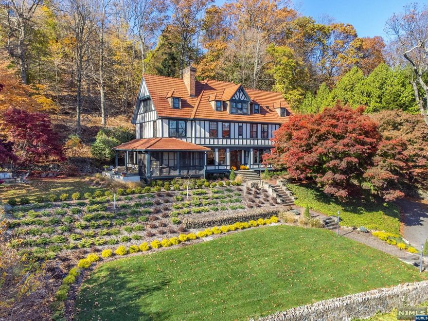 STUNNING RENOVATED TURN OF THE CENTURY COLONIAL-TUDOR WITH NYC SKYLINE VIEWS! Minutes from downtown, this home consists of 6 BR, 5.1 BA located in the coveted estate sec and over an acre of wooded land. Completely renovated with style & elegance. A SHOWCASE Chef's kitchen equipped with high end appliances, Sub Zero, Wolf Six burner French top, Wolf ovens, Miele Dishwasher, Wine fridge, Cust hood, Center island w/leathered granite counter, ceramic tiles, designer lighting throughout and cozy sitting are, with radiant heat in kitchen. New mud rm, 1st flr powder Rm off hallway. Grand entrance leads to LR with Gas FP, built-in and beamed ceilings, architectural details. Office/Library, Formal DR, Fam Rm Solarium with radiant heat flr. Primary BR suite with your DREAM dressing Rm, Closets, Full Bath shower, C/A, Alarm sys, Sonos sys, Laundry Rm, Third Fl consists of 2 BR, 2 BA, Rec Rm, Storage. 3 Car Garage, lots of updates to mention. Close to NYC trans. Exquisite home