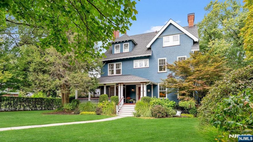 Prepare to be captivated by 89 Porter Place where classic elegance, modern updates, and an exceptional setting come together in one of Montclair's most beloved neighborhoods. Set on a beautifully landscaped lot with mature plantings that bloom year-round, this 6-bedroom, 3.5-bath Colonial is a rare blend of beauty, privacy, and effortless living. Sunlight floods the home, beginning in the gracious foyer with its striking open staircase that connects all three levels. The main floor flows seamlessly, featuring gleaming hardwood floors and spacious living, dining, and family rooms perfect for entertaining or relaxing. The renovated kitchen impresses with custom Parsons cabinetry, granite countertops, built-in bench seating area, and a center island. French doors off the dining room open to the most enchanting screened-in front porch, while a wisteria-draped pergola shades the rear deck both enhanced with Sonos speakers, along with the kitchen. Upstairs, the second level offers a primary suite with full bath, two generous bedrooms, another full bath, and flexible walk -in closet with laundry. The third floor features three more bedrooms with soaring ceilings, an additional full bath and plenty of storage ideal for guests, work, or creative space. Extras include, central air, main level powder room, exterior-access elevator, finished lower level and a two-car garage. Just minutes from the vibrant downtown Montclair, 89 Porter Place is gracious, inviting, and truly one of a kind.