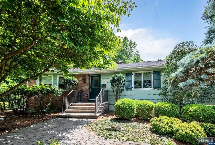 Charming 3-bedroom ranch in the picturesque town of Allendale. Situated on a .85-acre lot with beautiful perennial gardens, this home offers serene living in a prime location. Enter the sunlit foyer with a domed skylight, leading to the living room with built-ins & a cozy fireplace. The dining room opens to an updated Ulrich kitchen featuring high-end appliances and a breakfast nook. Enjoy outdoor living on the newly rebuilt deck overlooking the gorgeous and expansive yard. Down the hall, you'll find 3 bedrooms, including the primary ensuite with its own bath, and an additional hall bath. The newly finished lower level provides extra living space with a large open rec room, laundry room and access to the 2-car garage. Located close to all 3 schools, Crestwood Lake, downtown Allendale and NYC transportation, this home combines convenience and beauty in an unbeatable setting.