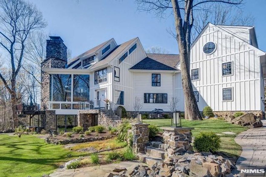Priced to sell quickly, this is a rare chance to own something truly special - where architecture becomes art and every detail tells a story. Crafted with intention and extraordinary precision, this home offers a sense of elegance and wonder that resonates the moment you enter. Sunlight pours through soaring ceilings and walls of glass, drawing your eye to the peaceful beauty of the Rockleigh Woods Sanctuary with private trails from the house. The connection to nature is effortless, creating a feeling of calm, privacy, and quiet luxury. The great rm is nothing short of breathtaking, with its dramatic scale, fireplace, and seamless flow into grand living and dining spaces, anchored by a stunning glass-enclosed wine cellar. The chefâ€™s kitchen is both warm and refined, featuring rich walnut cabinetry, quartz countertops, and premium appliances that invite gathering and everyday indulgence. The primary suite is a retreat of its own, with elevated ceilings and a spa-like bath designed for rest and renewal. 5 additional bedrooms, including a private in-law suite with its own sitting area, offer comfort and flexibility, while a loft provides additional space to live, work, or unwind. Downstairs, a true escape awaits - an entertainerâ€™s dream with a bar, gym, sauna, and a remarkable 46-foot indoor pool with an ozonator system for a fresh, chlorine-free experience. Smart home technology, elevator access to all 4 floors. This home is as thoughtful as it is unforgettable. Needs some