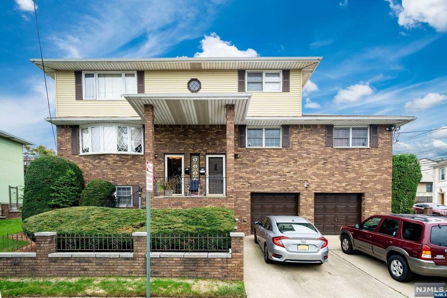 Super spacious corner two family with plenty of potential! The home is located on a 7500 square foot corner lot and close proximity to parks, schools, mass transit and shopping. First floor features an open floor plan with large living room, dining room and eat-in-kitchen with a center island, master bedroom with master bath and two additional bedrooms with a main bath. Lower finished level offers a family room with fireplace, dining area, half bath and laundry. Second floor offers a living room, eat-in-kitchen, two bedrooms and a full bath. All separate utilities, central A/C, hardwood floors, Attached 2 car garage and much more!