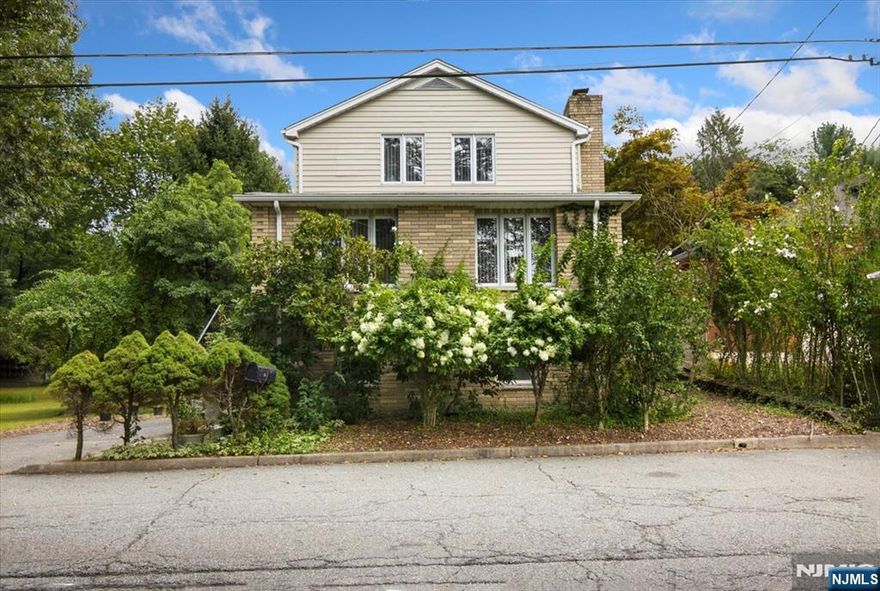 Welcome to this beautiful and sun-drenched 4-bedroom colonial, perfectly situated on nearly an acre of park-like property. Offering over 2,000 square feet of living space, this home combines classic charm with an abundance of room to live, work, and entertain.Step inside to find an expansive, extra-large kitchen designed for both everyday living and hosting. Just off the kitchen, a spacious deck overlooks the lush grounds, creating the perfect setting for outdoor dining or relaxing in a private, scenic setting.The home also features a finished basement, providing additional flexible living space for a recreation room, home office, or gym. A two-car garage adds convenience and plenty of storage.Located in a desirable neighborhood, you'll enjoy easy access to schools, parks, shopping, and NYC transportation, making this home an ideal choice for both tranquility and convenience.