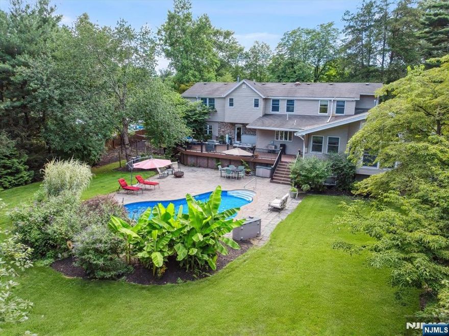 Welcome to a rare and extraordinary offeringâ€”a beautifully updated, non-conforming two-family residence nestled on nearly an acre of lush, private grounds. At almost 6,000 Sq Ft of living space, this unique property is truly one of a kind, blending rustic elegance with modern convenience and designed to impress at every turn. The main home features a spacious, open layout ideal for both everyday living and entertaining. Warmth radiates throughout, with rich fieldstone accents and 2 fireplaces adding character and comfort. The gourmet kitchen is a dream come trueâ€”outfitted with double ovens, two dishwashers, and an abundance of counter spaceâ€”a true entertainerâ€™s delight. Host unforgettable gatherings in the banquet-size FDR, or step outside to your private staycation yard, with a newer in-ground pool with waterfall, custom oversized deck with hot tub, and manicured landscaping that feels like a resort. Upstairs, the primary suite offers a peaceful escape with a walk-in closet and private balcony overlooking a tranquil man-made fish pondâ€”perfect for morning coffee or evening relaxation. What makes this property even more special? The attached, cottage-style side-by-side two-story apartment, ideal for extended family, guests, or rental income. The apartment rental can cover the property taxes and then some, making this not only a spectacular home, but a smart investment. A rare blend of lifestyle, location, and valueâ€”this is truly a one-of-a-kind home and opportunity