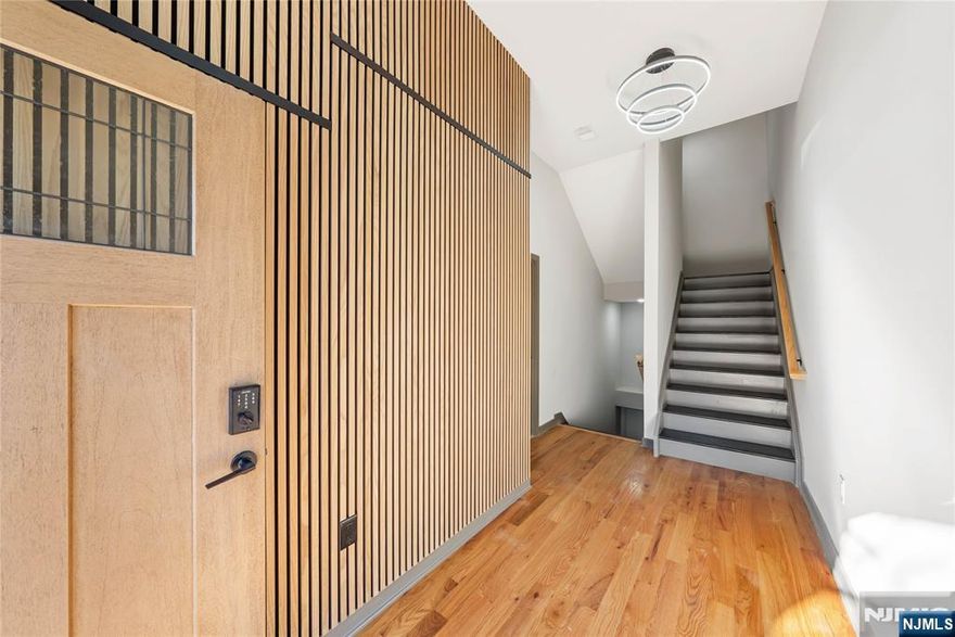 Step into this sleek and modern 2-bedroom, 3-bathroom home spanning three levels of living, giving it the feel of a townhouse. High ceilings and sun-drenched rooms with abundant windows create an open, airy atmosphere. The contemporary chef's kitchen features quartz countertops, GE stainless steel appliances, stylish pendant lighting, and ample cabinet space. Enjoy the convenience of an in-unit washer and dryer for effortless everyday living.The bathrooms impress with marble-style tile, dark gray flooring, and chic black hardware, adding a touch of luxury. Step outside to the rooftop terrace to unwind or entertain while taking in rare NYC skyline views a true standout in this area!Perfectly situated just steps from Ferry Street's restaurants, caf s, shops, parks, and major transit options, this home combines style, convenience, and modern comfort. Resident parking is available, making life even easier. A must-see for anyone seeking contemporary living in a prime Newark location!