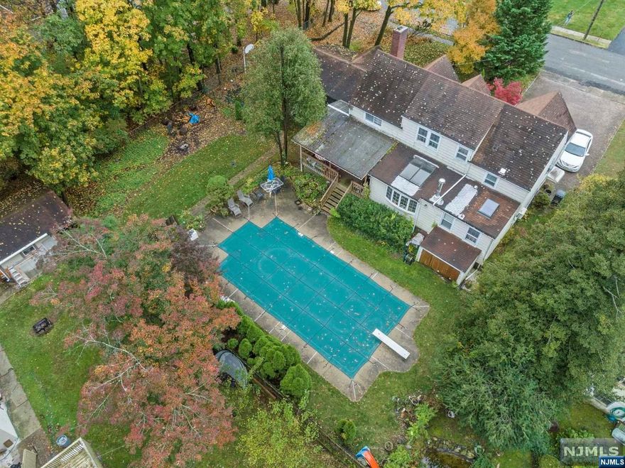 Nestled in a serene cul-de-sac, this charming home, which sits on a third of an acre, offers over 2200 sqft. of comfort. Featuring three bedrooms and two full baths, it includes a two-car garage and a double driveway for added convenience with outdoor storage space. Enjoy sunny days by the inviting in- ground pool or relax on the covered porch with plenty of space for entertaining. This home offers a nice size living room, dining room, family room, bar, office space and fully finished basement. With a personal touch and a little TLC this property can be your dream home. Home is sold as is.