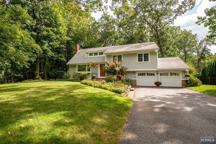 This perfect split level home is nestled into one of the most desirable streets in Packanack Lake. Only a short walk to GW Middle School. Take comfort in knowing that your lush landscape has an in ground sprinkler system. Long flat driveway. Once inside, you'll find the floor plan has made optimal use of all spaces &is nothing short of inviting. Liv rm is adorned w/a wood-burning fireplace & large bay window, allowing light to pour over into the adjoining din rm. Huge kitchen includes immense amount of cabinets, granite countertops, skylight, expanded eating area& slider to large composite deck overlooking level backyard. Down a few steps off liv rm is the fam rm w/ large closet, half bath, &access to the bbasement/laundry/storage/utility rm. Also, access to backyard w/large storage rm beneath deck.Up a few steps from liv rm is 2nd floor w/3 sizable bed rms all w/hardwood, double closets, & 1 full bath w/tub shower. 3rd floor has master bed rm suite w/3 closets & Full bath.