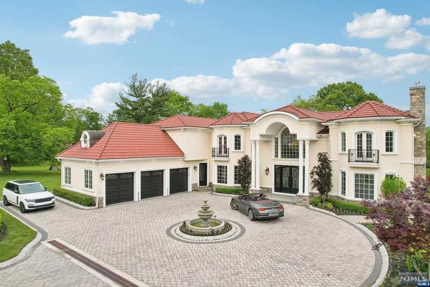 Exquisite Mediterranean villa nestled on a pristine 1-acre property in the heart of Paramus, New Jersey. This magnificent bespoke 3 year old home offers over 10,000 square feet of opulent living space across three levels. Long paver driveway leads to a stunning front courtyard centered around a grand fountain. The home's stucco exterior, complemented by a terracotta roof, exudes timeless Mediterranean charm. The spacious living and dining areas are designed for both grand entertaining and intimate gatherings, featuring high ceilings, expansive windows, and elegant finishes. Stunning kitchen boasts a large center island, top-of-the-line appliances, and custom cabinetry. Adjacent to the main kitchen is a convenient service kitchen. This residence offers 8 generously sized bedrooms, three of which can serve as primary suites. Multiple balconies, decks and patios present a variety of options for outdoor enjoyment. Elevator available on 3 levels. Smart Home offers every convenience.
