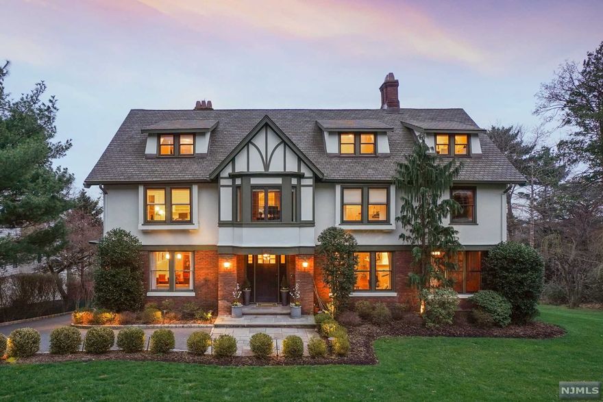 This gracious Tudor welcomes skyline views throughout. The heart of the home is the gourmet kitchen, filled with sunshine and designer appliances it flows directly into the great room with gas fireplace and large deck, creating an entertainer's dream. Library has beautiful molding and fireplace, perfect WFH space. Primary bedroom features a gas fireplace visible in both the bedroom and primary bath, walk in closets and private porch area. The expansive finished walk-out basement has direct access to backyard, a large mudroom, game room, media room, full bath, wine storage an additional room for office or guest space. With 7 beautiful bedrooms and so much room in basement there are loads of opportunities for multiple WFH spaces and guests. Both Watchung and Upper Montclair train stations less than a mile away.