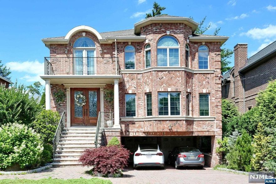 12 Years all brick colonial house in Palisade Garden Section. Quality craftsmanship & materials throughout open floor plan. Home features 4 Br with 4.5 baths.Finished Ground Floor features Bedrm/Fbth,Laundry,Rec Rm, garage. Two story foyer . Three stop premium residential Elevator. Spacious gourmet kitchen offers a Sub-Zero & Wolf appliances, center Island w/granite tops & custom all wood cabinet,sliding door to the Patio and back yard. Living room w/ cherry wood coffered ceiling. Formal dining room. family room/ gas fl, room pre-wired for surround sound system, 97% ultra-efficient Triangle Tube radiant heating system with Smart hot water system, 3 separate air conditioning systems. hardwood floors.Full house GENERATOR, ELEVATOR,security system.MUST SEE!