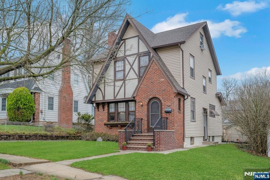 Well-maintained 3BR Tudor Colonial just steps from Verona Park and set in the award-winning Forest Avenue School district! This inviting home is rich in character, featuring a rounded-top entry door, leaded glass windows, and gleaming wood floors throughout. The EIK with charming breakfast nook flows seamlessly into the main level, complete with a convenient powder room. Upstairs offers three bedrooms and a full bath, while the walk-up attic additional space.Enjoy a well maintained basement rec room, an enclosed rear porch perfect for relaxing, and a level yard offering both sun and shade. Additional highlights include abundant storage and a 1-car detached garage. Ideally located near top-rated schools, shopping, NYC transportation, and major highways with easy access to Verona Park this home delivers the perfect blend of timeless charm, prime location, and endless potential.