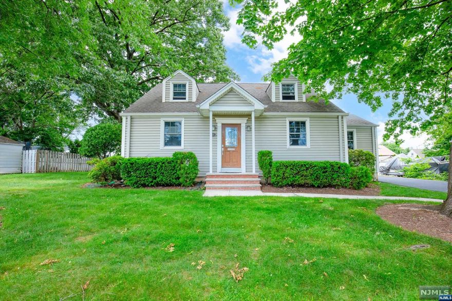 For more information, please contact Andrew Delgado- 347-502-854 Nestled on a double lot in beautiful Bergenfield, NJ, this 1869 Sq Ft charming four-bedroom, two-bath custom built, center hall Cape Cod home offers inviting spaces and modern amenities. Upon entering, you'll find hardwood floors throughout the living and dining rooms, as well as two versatile bedrooms currently used as a den and an office. The bright and airy eat-in kitchen opens to an oversized deck, perfect for entertaining or unwinding in a serene setting. The upper level features a primary bedroom, an additional bedroom, and a full bath. While the basement is unfinished, it is spacious and serves as a utility, laundry, and storage area, offering plenty of customization. The newly paved driveway leads to a two-car garage and a shed, adding convenience and storage options. Bergenfield's prime location is less than 20 minutes from NYC, offering an ideal suburban retreat with easy access urban amenities.