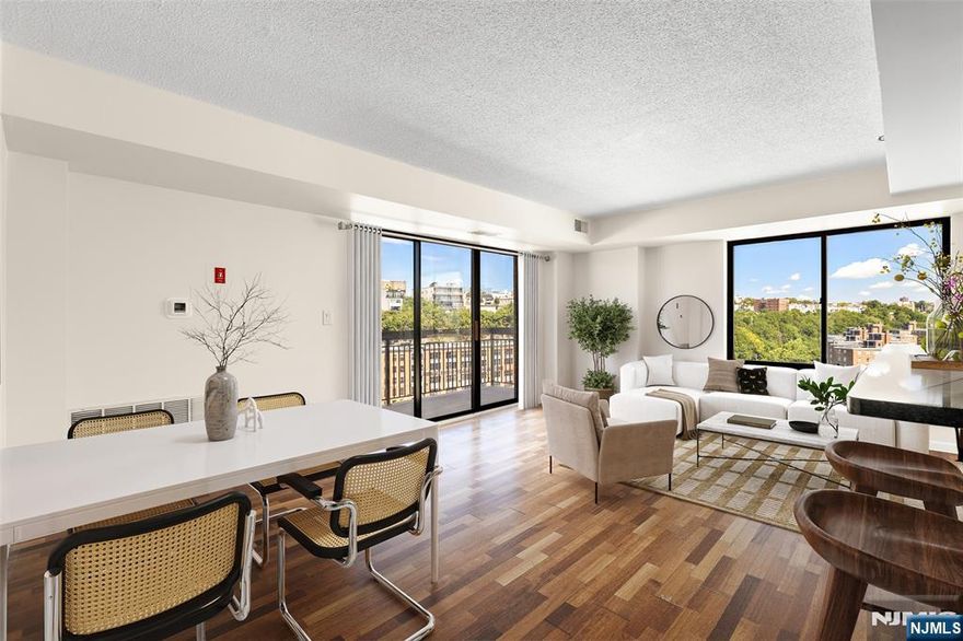 Located on the 12th floor of The Sky Club, a premier 17-story full-service doorman building in Hoboken, this stunning corner home offers 1,273 square feet of sun-drenched living space with partial Manhattan views. A rare three-bedroom condo offering in the sought-after southwest side of Hoboken, this residence features a thoughtfully designed layout with two full bathrooms, each with new vanities, and a private balcony. The expansive living room flows seamlessly into a gourmet open kitchen appointed with stainless steel Whirlpool appliances, a tiled backsplash, a wine rack, ample cabinetry, and a breakfast bar. Brazilian Cherry hardwood floors grace the main living areas, complemented by brand-new flooring in the bedrooms. Additional highlights include central heat and air conditioning, a new in-unit washer/dryer, and abundant closet space. The Sky Club provides an unparalleled lifestyle with a 24-hour doorman and concierge, commuter shuttle service to the Hoboken PATH, a 25,000-square-foot on-site health club with an Olympic-size indoor swimming pool, and the convenience of an on-site parking garage. Ideally located in Southwest Hoboken, the building is adjacent to Southwest Park and the 2nd Street Light Rail stop, and just minutes from the PATH, restaurants, and shopping.