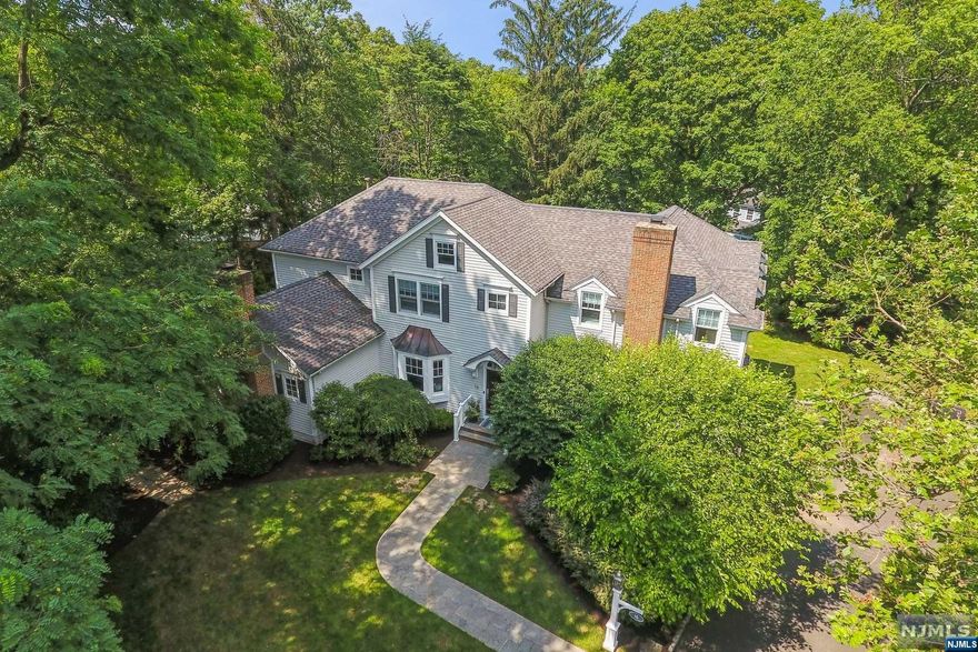 Stunning Short Hills showstopper! Decorator's own sensationally renovated custom colonial at end of a quiet cul de sac. Formal Living Room showcases a statement fireplace and deep crown moldings. Dining Room with custom window seat leads to spectacular open concept Chef's Kitchen with oversized island, high-end stainless steel appliances, quartz counters and breakfast area with direct access to patio overlooking the lush, level yard plus access to private deck via Butler's Pantry. Family Room provides a 2nd fireplace and builtins. 1st floor Bedroom / Office, Laundry Room and updated Powder Room complete the 1st level. Sumptuous Primary Bedroom Suite with vaulted ceiling, 2 large walk-in closets, sitting area / home office + Primary Bath with dual sinks, jetted soaking tub, shower and commode room. 3 additional bedrooms on this level (one en-suite) + 3rd Full Bath. Lower Level with Recreation Room, Gym and Full Bath + oversized 3-car attached garage and Mud Room.