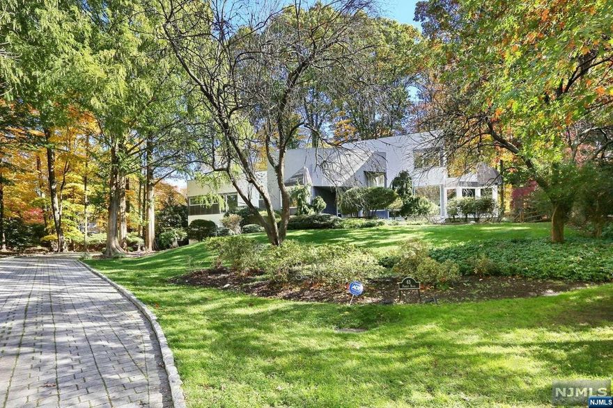 Enchanting sun-drenched unique contemporary property-Augusto Morpurgo award winning home over 5,000 sqft living space in the most exclusive section of Tenafly's East Hill.This home was completely&meticulously renovated in 2020 -finest materials&quality,no detail over-looked.Impressive floating circular staircase overlooking grand 2 story great rm w soaring ceilings,floor to ceiling marble wood-burning fire pl,16' high glass wall exposing the expansive deck for capturing the stunning sunset views of park-style landscaping.1st fl:large,luxury,modern eat-in-kitchen w oversized island,high end appliances,quartzcounter-top,glass wine cellar,large breakfast area,formal dining rm.A large master suite w office,sitiing rm,two large walk-in closets,built-in vanity,full spa bath.Jr. Master Suite, music room,powder rm,gym,laundry.2ndfl:3 large bedrms,2 full bath.Ground fl:media rm,bedrm,full bath,dark rm,recreation area,storages,heated 4 car garage w Tesla charging station.A Very Special Home